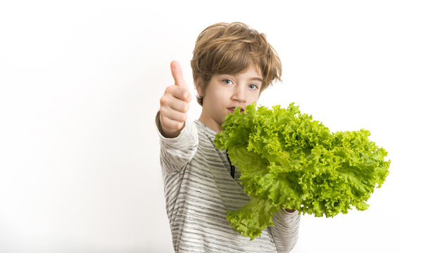 Portrait of a boy with letuce and tumb up