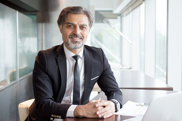 Portrait of successful financier at paperwork