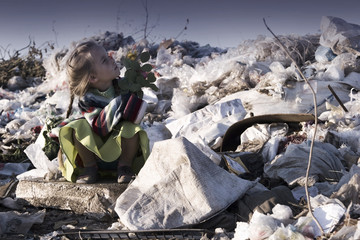 The poor girl in the dump looked up at the sky