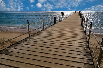Wooden bridge with cloudy blue sky