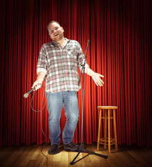 Studio portrait of a young showman with the microphone