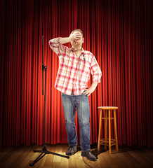 Studio portrait of a young showman with the microphone