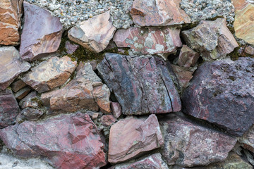 Stone wall. multicolor stone texture. Pink granite and colored marble.
