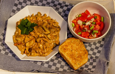 Mushroom stew with parsley,tomato salad and bread