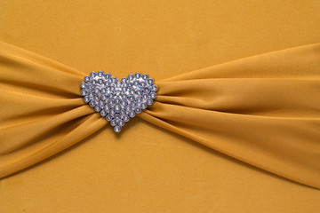 Jewelry hart shape on golden cotton