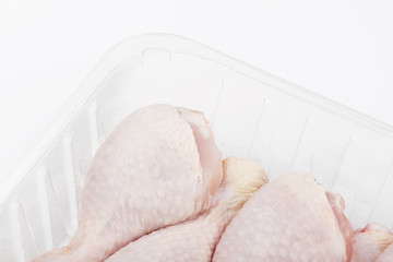 Horizontal shot of pile of raw chicken thighs isolated on white. Packaged chicken. Copy space. Isolated.