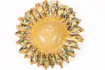 Sun pie stuffed with light cheese and spinach in white background seen from above