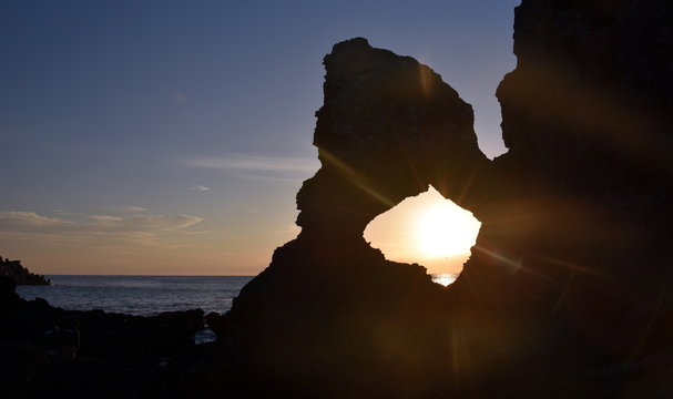 Sunrise at Australia rock in Narooma. The shape of Australia cut into the rock wall was accidental and was created when a ship was tied to the rock with large chains to prevent it from washing away.