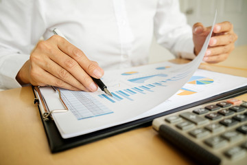 Business concept. Business people discussing the charts and graphs showing the results of their successful teamwork.