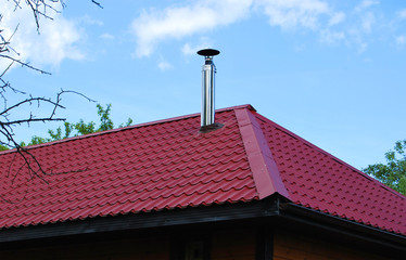 Red metal roof with iron chimney