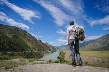 Young woman walking along the in the National Park. To dream of looking at the river.