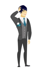 Young asian bridegroom laughing.