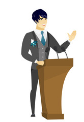 Asian groom giving a speech from tribune.