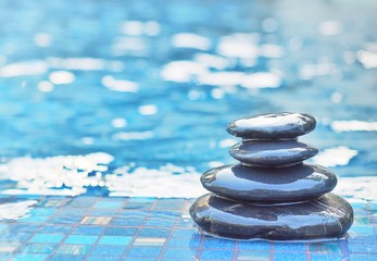 stacked stone on floor swimming pool background