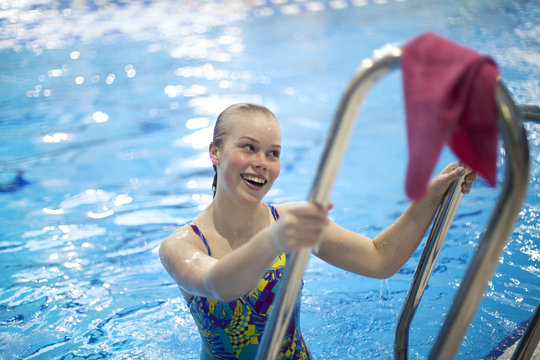 Girl coming out from the pool