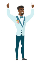 Groom standing with raised arms up.