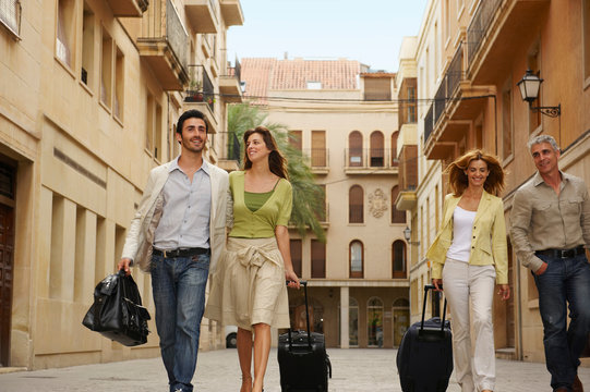 Two couples with cases walking
