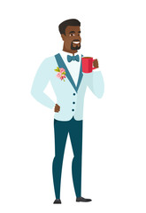 Young african-american groom holding cup of coffee