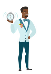 African-american groom holding alarm clock.