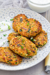 Vegetarian quinoa, carrot, coriander and green onion fritters served with yogurt, vertical