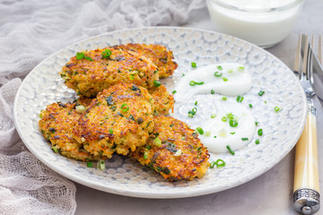 Vegetarian quinoa, carrot, coriander and green onion fritters served with yogurt, horizontal