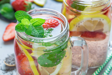 Healthy detox chia seed drink with strawberry, lemon and mint in glass jar, horizontal, closeup