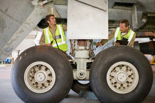 Aircraft workers checking airplane