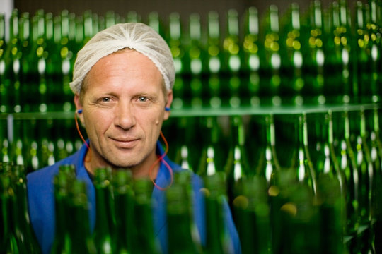 Worker standing in bottling plant