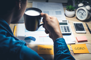  businessman holding cup of coffee on workplace.Spark,refresh,healthy concept