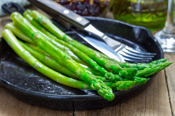 Freshly cooked asparagus appetizer on a cast iron skillet