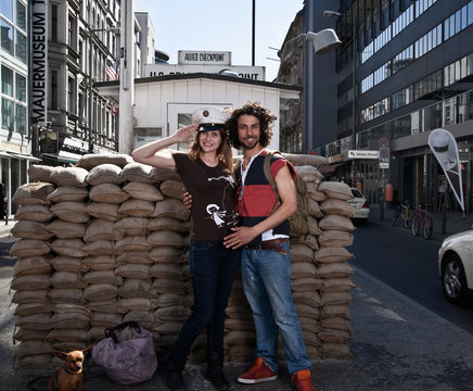Couple smiling at Checkpoint Charlie
