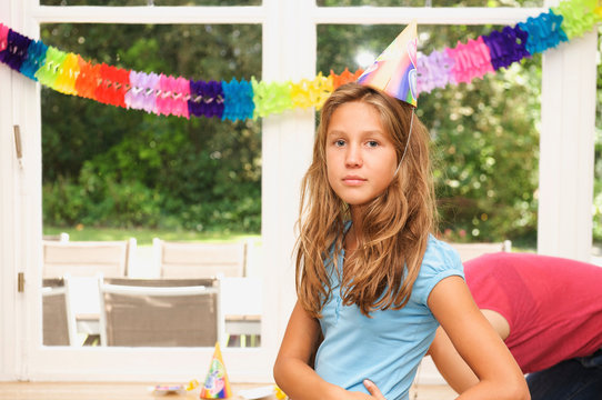 Girl wearing hat at birthday party