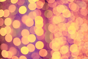 Christmas abstract shiny light bokeh in violet pink colors, vintage retro hipster seasonal holiday background