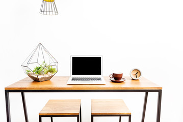 Notebook with beverage mug and watch on desk