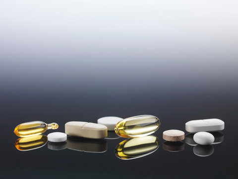 Close up of pills on reflective surface