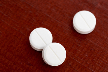 Closeup of three white pills