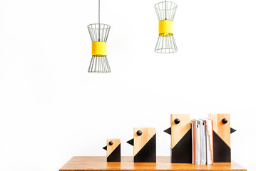 Statuettes for interior setting with pile of books on desktop