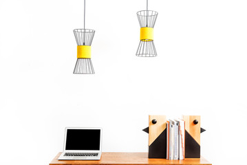 Notebook and statuettes for room decoration with notebooks on desktop