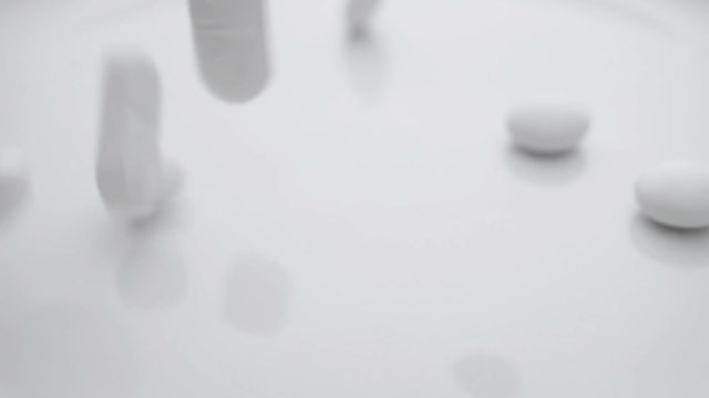 Medical pills falling down in slow motion.
