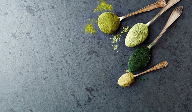 Assorted organic green Super Foods. Kale, chlorella, green barley, green oat.