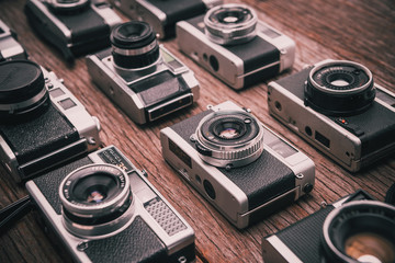 Retro film photo camera on wooden background - Powered by Adobe