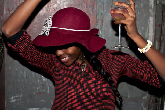Woman in hat drinking at party