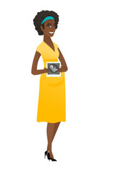 Pregnant african woman showing ultrasound scan.