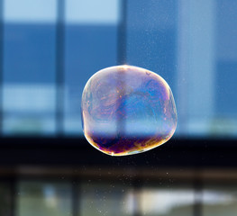 Beautiful soap bubbles fly in the city