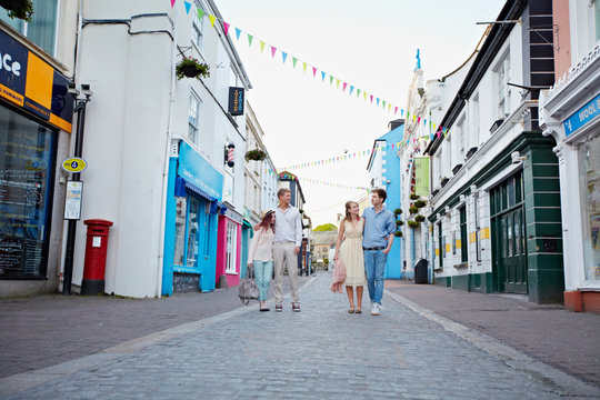 Couples walking together on city street