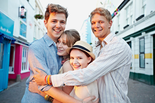 Couples hugging on city street