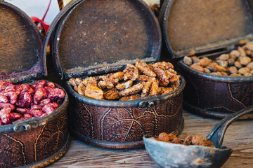 Scandinavian sweetness. Fried spicy nuts. Tallinn, Estonia. Nuts with spices Scandinavian delicacy.