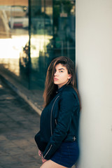 Pretty teenage girl posing on the street