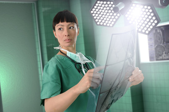 Female surgeon with scans