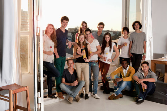 Group of friends at house party on balcony